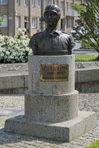 Avranches, France - Apr 13, 2024: General Patton square, Avranches. Monument and Sherman Thunderbolt tank. Sunny spring day. Selective focus
