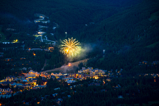 Aerial view of fireworks over ski town in winter,  Whistler, B.C.