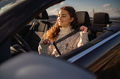 Girl fastening seatbelt in a car