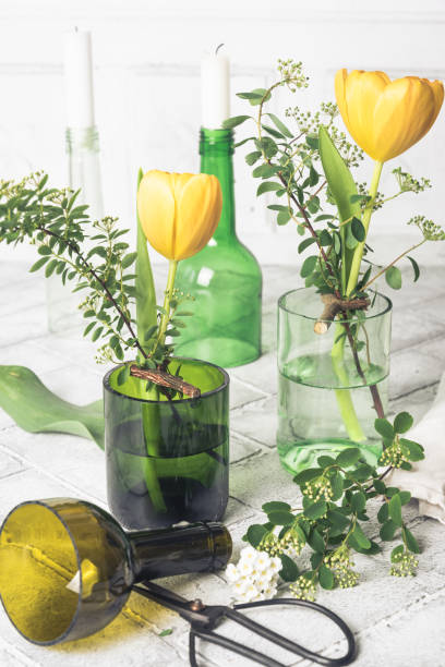 istock Candlesticks and vases on a white background, decoration made from green wine bottles, craft tip 2148724938