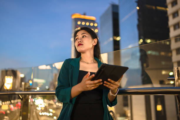istock Young lady using digital tablet in balcony against city background 2148726294