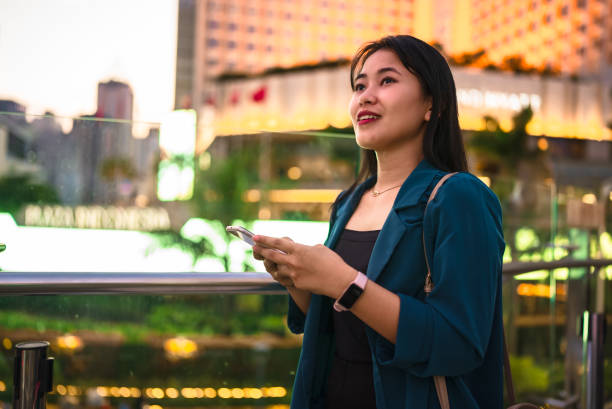 istock Young lady using digital tablet in balcony against city background 2148726382