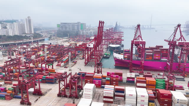 Overall busy activity in Hong kong Asia port. Global supply chain and transportation concept related with shipping and business. Drone video dolly shot accelerated motion.