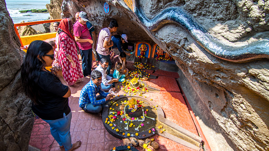 Devotees at Gangeshwar Mahadev Temple is praying to  Lord Shiva located at seashore of Diu