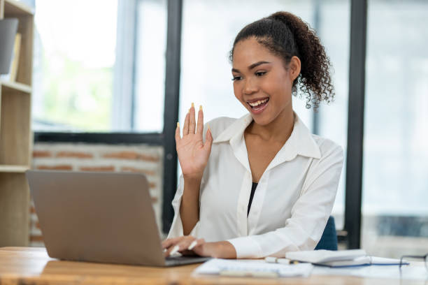 istock Focused young businesswoman analyzing financial reports at a modern workspace with a laptop and office supplies. 2148730475