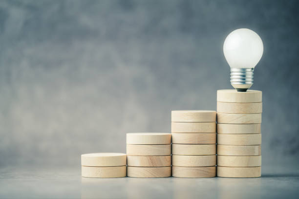istock Glowing light bulb at the top stage of step stairs 2148731190