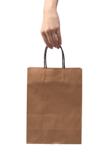 istock Paper bag in woman hand isolated on a white background. 2148731343
