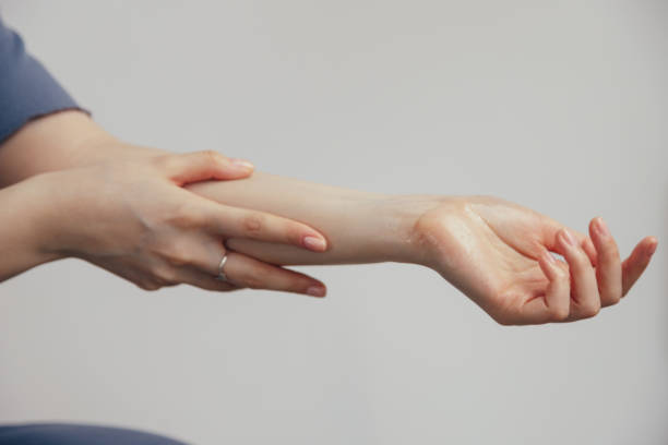 istock A hand gesture holding wrist with fingers and thumb 2148732422