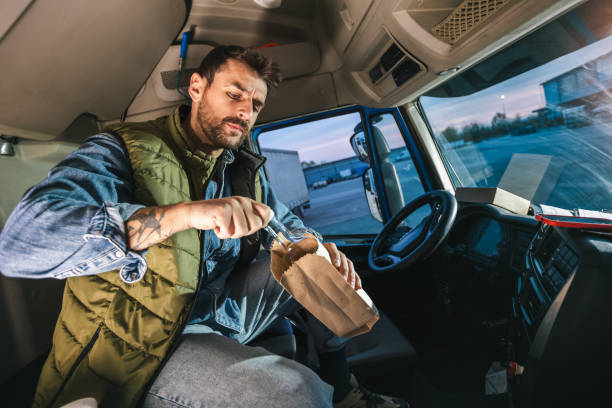 istock Young handsome man driving long vehicle, taking a break from long ride and drinking some alcohol. 2148732438