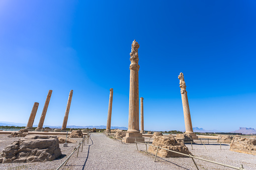 Towering columns and intricate carvings showcase the architectural brilliance of Persepolis. A UNESCO World Heritage Site, it echoes the grandeur of a bygone era. Persepolis, Iran.
