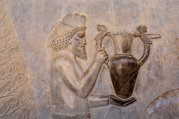 Detailed carving of a noble figure with an ornate vessel, showcasing the intricate artistry of ancient Persia. Highlighting the skilled craftsmanship. Persepolis, Iran.