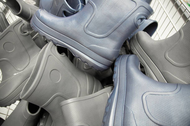 Pile of many rubber rain boots. Shoe background