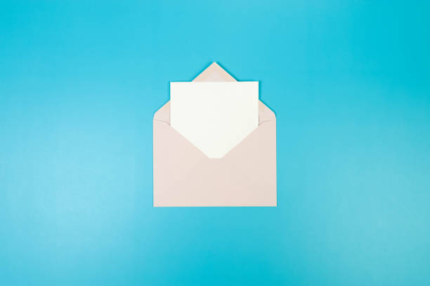 istock Top view of light pink envelope, white card on blue background. 2148734183
