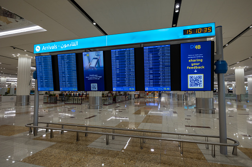 Dubai, United Arab Emirates - March 31, 2024 : Flight information board at the Dubai International Airport Terminal 3.