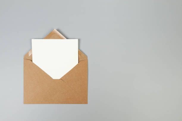 istock Top view of kraft brown envelope, white card on grey background. 2148734435
