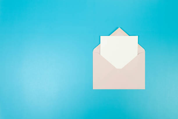 istock Top view of light pink envelope, white card on blue background. 2148734462