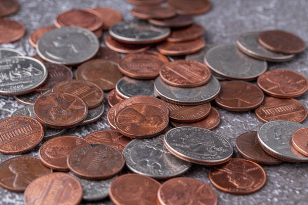 American coins and US dollars on a wooden table