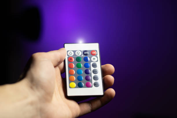 istock Man is adjusting Atmosphere Neon Light with Remote Control.
Colorful RGB Bulb. LED Multicolor Lump. Household Lighting. Blogging and business modern cool lighting. 2148734845