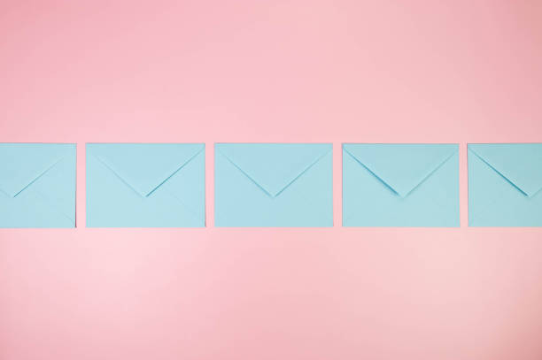 istock Top view of light blue envelopes on pink background. 2148735502