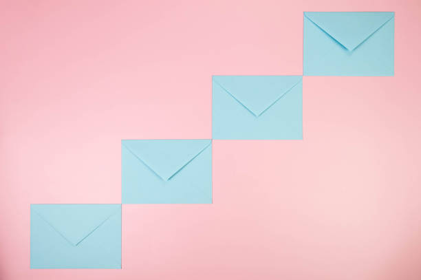 istock Top view of light blue envelopes on pink background. 2148735503