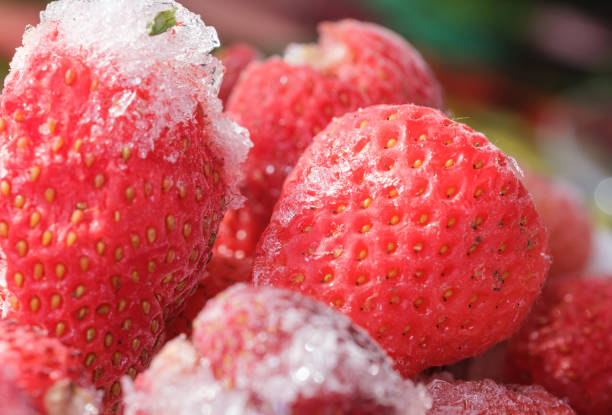 istock frozen red strawberries with ice close-up 2148735549