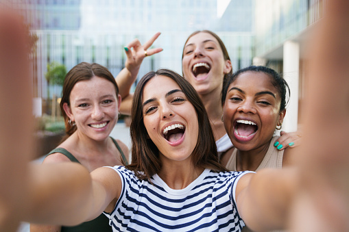 Happy girls taking a selfie photo for social media - Group of Women Students smiling at University