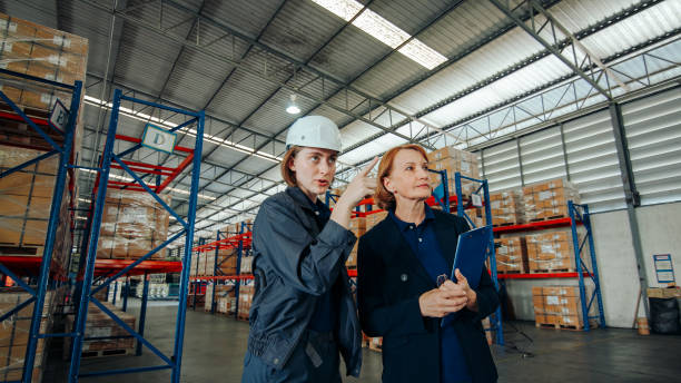 istock Logistics professionals converse while walking through the aisles of a storage facility, focused on improving operational processes. 2148737432