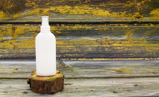 White cosmetic spray bottle mockup on old rustic wooden background