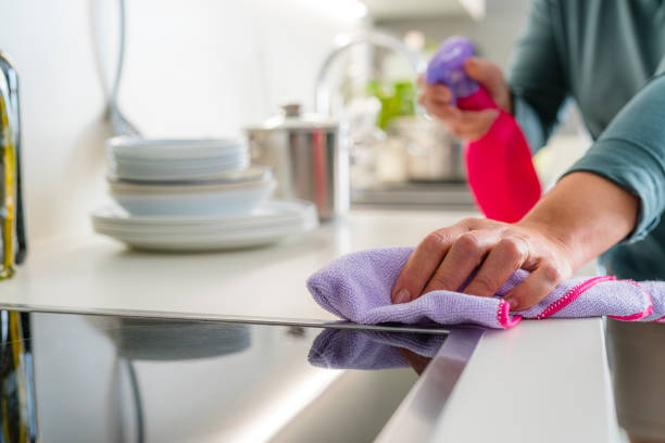 istock Woman scrubbing dirty kitchen counter 2148739185
