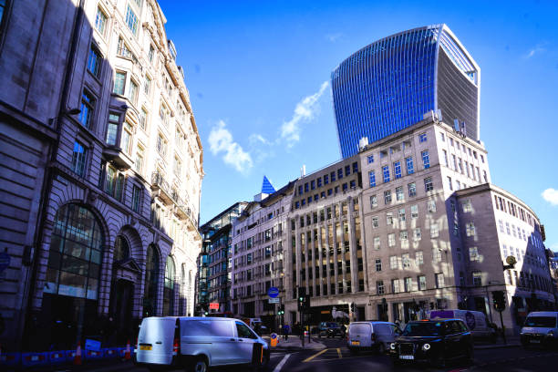 London, England, United Kingdom, Great Britain, Europe - February 11, 2024: King William Street, The City Of London Financial District, East London. King William Street, Monument Underground Station In The City Of London Financial District, East London.modern office blocks and buildings, a significant architectural landmark in england. the glow of office windows. the modern office buildings, several office blocks. prominent office towers, a cohesive urban environment and high-density living, a large residential, cultural, office complex and prominent examples of british architecture. a contemporary office building.