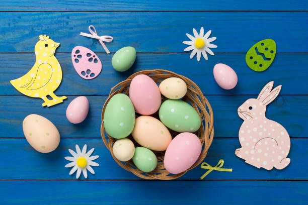 istock Easter eggs and cute decoration on wooden background, top view 2148743270