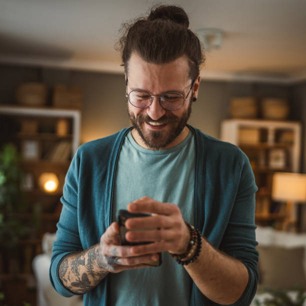 istock man with eyeglasses write message or browse internet hold mobile phone 2148744194