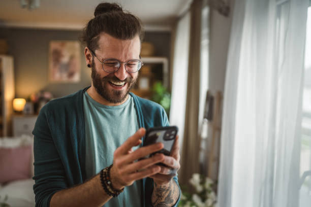 istock man with eyeglasses write message or browse internet hold mobile phone 2148744222