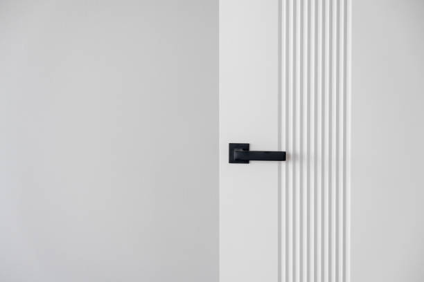 istock Modern black door handle on white wooden door in interior. 2148744353