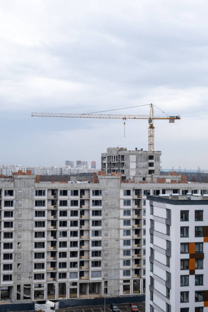 istock crane and a building under construction against a blue sky background 2148744474