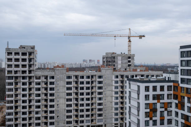 istock crane and a building under construction against a blue sky background 2148744651