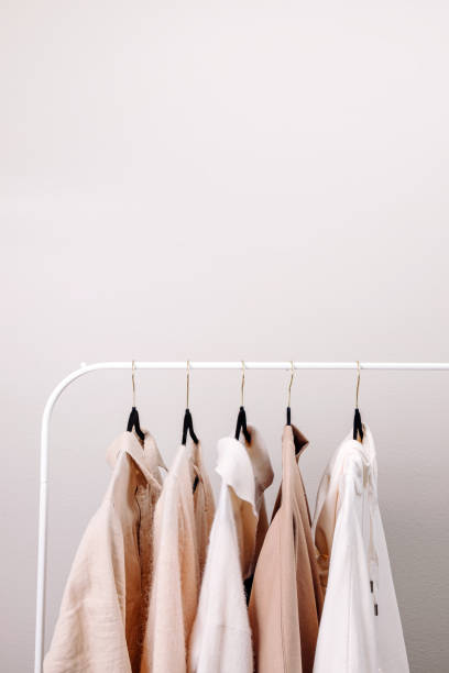 istock Women's clothes on the rack. Minimal wardrobe 2148744695