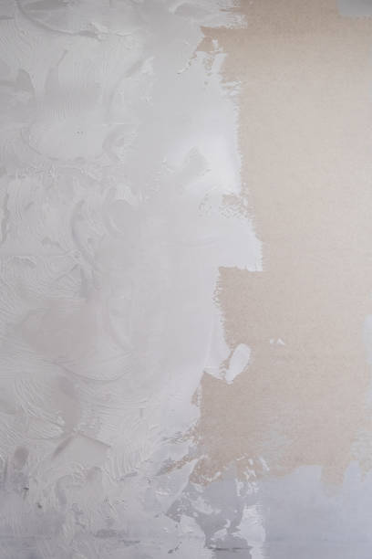 istock Applying decorative putty. White abstract texture of surface covered with putty 2148745518