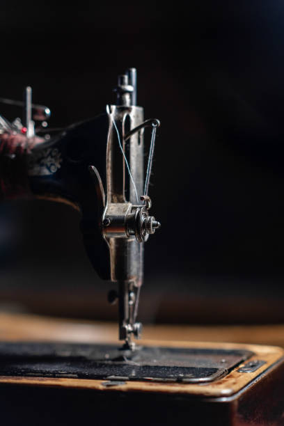 istock Old sewing machine stands on the table at home ready to work and sew. 2148745556