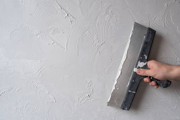 istock Applying decorative putty. White abstract texture of surface covered with putty 2148745666