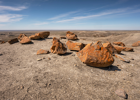 Pieces of red concretions on the horizon at Red Rock Coulee near Seven Persons, Alberta, Canada