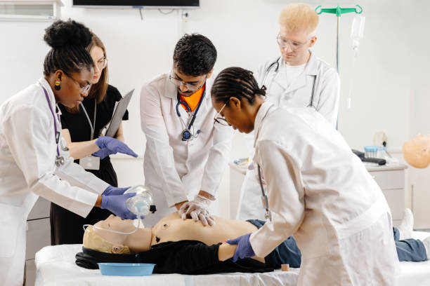 istock Group of people learning how to make first aid heart compressions with dummies during the training 2148746028