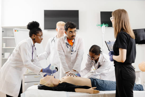istock Group of people learning how to make first aid heart compressions with dummies during the training 2148746029