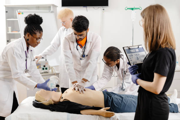 istock Group of people learning how to make first aid heart compressions with dummies during the training 2148746045