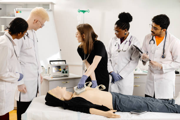 istock Instructor teaching first aid cardiopulmonary resuscitation course and use of automated external defibrillator workshop 2148746101
