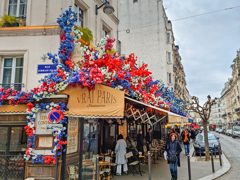 Paris, France - 6 March, 2023: Bistro in the streets of Montmartre in Paris, France. The place is famous by its cafes, artists, shops and night life.