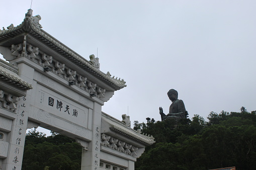 View of Tian Tan Buddha and traditional gate, Hong Kong.