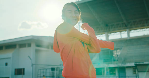 istock Young Asian female athlete runner stretching warm up exercise before running exercise getting ready for jogging outdoors. Healthy workout exercise. 2148747243