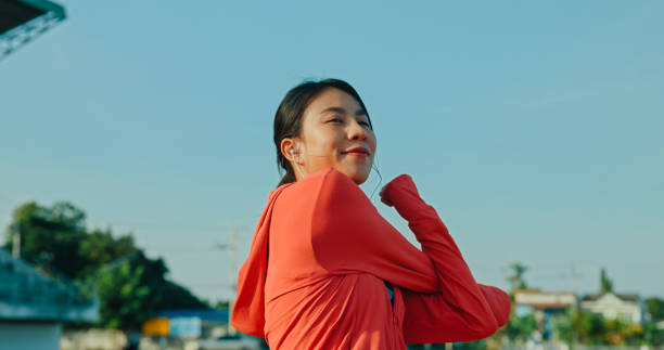 istock Young Asian female athlete runner stretching warm up exercise before running exercise getting ready for jogging outdoors. Healthy workout exercise. 2148747316