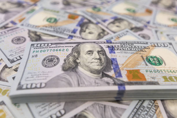 istock Pile of US 100 dollar banknotes on dollars background 2148747705